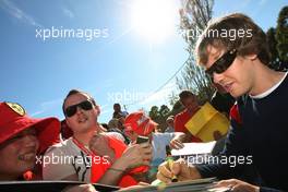 26.03.2010 Melbourne, Australia,  Sebastian Vettel (GER), Red Bull Racing Signing autographs,  - Formula 1 World Championship, Rd 2, Australian Grand Prix, Friday