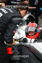 28.03.2010 Melbourne, Australia,  Michael Schumacher (GER), Mercedes GP Petronas adjusts his mirror  - Formula 1 World Championship, Rd 2, Australian Grand Prix, Sunday Pre-Race Grid