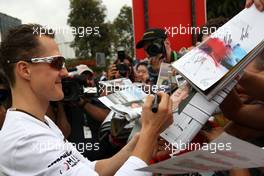 28.03.2010 Melbourne, Australia,  Michael Schumacher (GER), Mercedes GP Petronas signing autographs - Formula 1 World Championship, Rd 2, Australian Grand Prix, Sunday