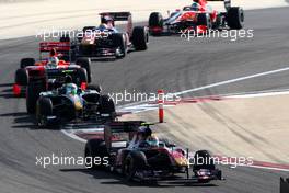 14.03.2010 Sakhir, Bahrain,  Jaime Alguersuari (ESP), Scuderia Toro Rosso, STR05 leads Heikki Kovalainen (FIN), Lotus F1 Team, T127 - Formula 1 World Championship, Rd 1, Bahrain Grand Prix, Sunday Race