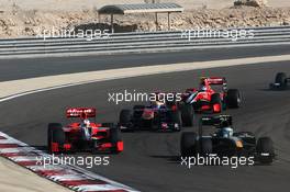 14.03.2010 Sakhir, Bahrain,  Timo Glock (GER), Virgin Racing VR-01 and Heikki Kovalainen (FIN), Lotus F1 Team, T127 - Formula 1 World Championship, Rd 1, Bahrain Grand Prix, Sunday Race