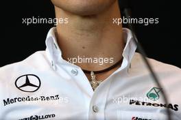 11.03.2010 Sakhir, Bahrain,  The necklace of Michael Schumacher (GER), Mercedes GP Petronas - Formula 1 World Championship, Rd 1, Bahrain Grand Prix, Thursday