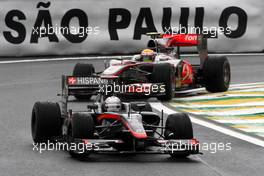 06.11.2010 Sao Paulo, Brazil,  Christian Klien (AUT), test driver,  Hispania Racing F1 Team, HRT leads Lewis Hamilton (GBR), McLaren Mercedes - Formula 1 World Championship, Rd 18, Brazilian Grand Prix, Saturday Qualifying