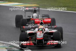 06.11.2010 Sao Paulo, Brazil,  Lewis Hamilton (GBR), McLaren Mercedes, MP4-25 leads Christian Klien (AUT), test driver,  Hispania Racing F1 Team, HRT - Formula 1 World Championship, Rd 18, Brazilian Grand Prix, Saturday Qualifying