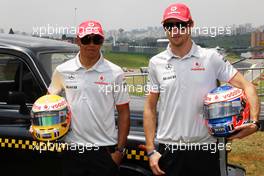 04.11.2010 Sao Paulo, Brazil,  Lewis Hamilton (GBR), McLaren Mercedes, Jenson Button (GBR), McLaren Mercedes with a London taxi - Formula 1 World Championship, Rd 18, Brazilian Grand Prix, Thursday