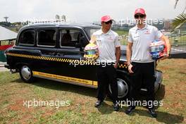 04.11.2010 Sao Paulo, Brazil,  Lewis Hamilton (GBR), McLaren Mercedes, Jenson Button (GBR), McLaren Mercedes with a London taxi - Formula 1 World Championship, Rd 18, Brazilian Grand Prix, Thursday