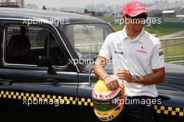 04.11.2010 Sao Paulo, Brazil,  Lewis Hamilton (GBR), McLaren Mercedes with a London taxi - Formula 1 World Championship, Rd 18, Brazilian Grand Prix, Thursday