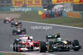 18.04.2010 Shanghai, China,  Heikki Kovalainen (FIN), Lotus F1 Team, T127 leads Fernando Alonso (ESP), Scuderia Ferrari, F10 - Formula 1 World Championship, Rd 4, Chinese Grand Prix, Sunday Race