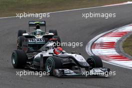 18.04.2010 Shanghai, China,  Michael Schumacher (GER), Mercedes GP Petronas, W01 leads Heikki Kovalainen (FIN), Lotus F1 Team, T127 - Formula 1 World Championship, Rd 4, Chinese Grand Prix, Sunday Race