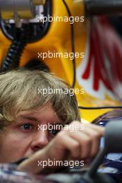 17.04.2010 Shanghai, China,  Sebastian Vettel (GER), Red Bull Racing, adjusts his new wing mirror - Formula 1 World Championship, Rd 4, Chinese Grand Prix, Saturday Practice