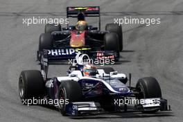 09.05.2010 Barcelona, Spain,  Nico Hulkenberg (GER), Williams F1 Team, FW32 leads Jaime Alguersuari (ESP), Scuderia Toro Rosso, STR05 - Formula 1 World Championship, Rd 5, Spanish Grand Prix, Sunday Race