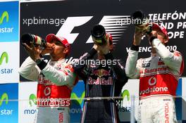 27.06.2010 Valencia, Spain,  Lewis Hamilton (GBR), McLaren Mercedes with 1st place Sebastian Vettel (GER), Red Bull Racing and 3rd place Jenson Button (GBR), McLaren Mercedes - Formula 1 World Championship, Rd 9, European Grand Prix, Sunday Podium