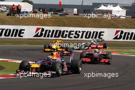 11.07.2010 Silverstone, England,  Mark Webber (AUS), Red Bull Racing leads Lewis Hamilton (GBR), McLaren Mercedes at the start - Formula 1 World Championship, Rd 10, British Grand Prix, Sunday Race
