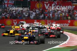 11.07.2010 Silverstone, England,  Mark Webber (AUS), Red Bull Racing leads at the start - Formula 1 World Championship, Rd 10, British Grand Prix, Sunday Race