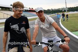 22.07.2010 Mannheim, Germany,  Sebastian Vettel (GER), Red Bull Racing walks the track and has a chat with Michael Schumacher (GER), Mercedes GP Petronas  - Formula 1 World Championship, Rd 11, German Grand Prix, Thursday