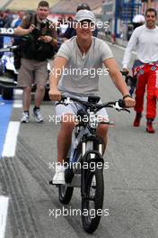 22.07.2010 Mannheim, Germany,  Michael Schumacher (GER), Mercedes GP Petronas with his electric bike - Formula 1 World Championship, Rd 11, German Grand Prix, Thursday