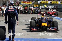01.08.2010 Budapest, Hungary,  Sebastian Vettel (GER), Red Bull Racing walks out of parc ferme as Mark Webber (AUS), Red Bull Racing the winner drives in - Formula 1 World Championship, Rd 12, Hungarian Grand Prix, Sunday Podium
