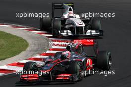 01.08.2010 Budapest, Hungary,  Jenson Button (GBR), McLaren Mercedes, MP4-25 leads Kamui Kobayashi (JAP), BMW Sauber F1 Team - Formula 1 World Championship, Rd 12, Hungarian Grand Prix, Sunday Race