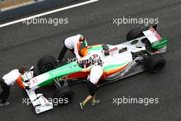 12.02.2010 Jerez, Spain,  Adrian Sutil (GER), Force India F1 Team getting pushed back to his box - Formula 1 Testing, Jerez, Spain