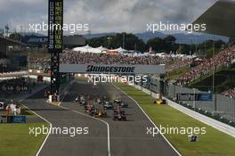 10.10.2010 Suzuka, Japan,  Sebastian Vettel (GER), Red Bull Racing leads the start of the race and Vitaly Petrov (RUS), Renault F1 Team crashes - Formula 1 World Championship, Rd 16, Japanese Grand Prix, Sunday Race