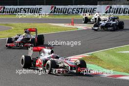 10.10.2010 Suzuka, Japan,  Jenson Button (GBR), McLaren Mercedes, MP4-25 leads Lewis Hamilton (GBR), McLaren Mercedes, MP4-25 - Formula 1 World Championship, Rd 16, Japanese Grand Prix, Sunday Race