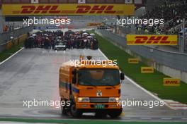 24.10.2010 Yeongam, Korea,  A road sweeper tries to remove some of the standing water whilst the drivers sit on the grid - Formula 1 World Championship, Rd 17, Korean Grand Prix, Sunday Race