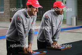 23.10.2010 Yeongam, Korea,  Jenson Button (GBR), McLaren Mercedes and Lewis Hamilton (GBR), McLaren Mercedes, hand printing session - Formula 1 World Championship, Rd 17, Korean Grand Prix, Saturday