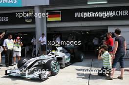 02.04.2010 Kuala Lumpur, Malaysia,  Nico Rosberg (GER), Mercedes GP Petronas leaving from the incorrectly labeled garage of Michael Schumacher (GER), Mercedes GP Petronas - Formula 1 World Championship, Rd 3, Malaysian Grand Prix, Friday Practice
