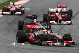 04.04.2010 Kuala Lumpur, Malaysia,  Lewis Hamilton (GBR), McLaren Mercedes, MP4-25 leads Sébastien Buemi (SUI), Scuderia Toro Rosso, STR05 - Formula 1 World Championship, Rd 3, Malaysian Grand Prix, Sunday Race