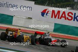 04.04.2010 Kuala Lumpur, Malaysia,  Lewis Hamilton (GBR), McLaren Mercedes leads Vitaly Petrov (RUS), Renault F1 Team - Formula 1 World Championship, Rd 3, Malaysian Grand Prix, Sunday Race