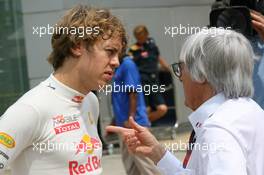 03.04.2010 Kuala Lumpur, Malaysia,  Sebastian Vettel (GER), Red Bull Racing talking with Bernie Ecclestone (GBR) - Formula 1 World Championship, Rd 3, Malaysian Grand Prix, Saturday