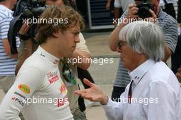 03.04.2010 Kuala Lumpur, Malaysia,  Sebastian Vettel (GER), Red Bull Racing talking with Bernie Ecclestone (GBR) - Formula 1 World Championship, Rd 3, Malaysian Grand Prix, Saturday