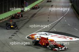26.09.2010 Singapore, Singapore,  Fernando Alonso (ESP), Scuderia Ferrari, F10 leads Sebastian Vettel (GER), Red Bull Racing, RB6 at the start of the race - Formula 1 World Championship, Rd 15, Singapore Grand Prix, Sunday Race