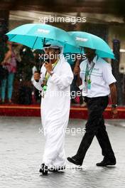 12.11.2010 Abu Dhabi, Abu Dhabi,  People use umbrellas in the rain, in the paddock - Formula 1 World Championship, Rd 19, Abu Dhabi Grand Prix, Friday