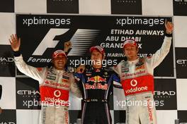 14.11.2010 Abu Dhabi, Abu Dhabi,  2nd place Lewis Hamilton (GBR), McLaren Mercedes with New world Champion and 1st place Sebastian Vettel (GER), Red Bull Racing and 3rd place Jenson Button (GBR), McLaren Mercedes - Formula 1 World Championship, Rd 19, Abu Dhabi Grand Prix, Sunday Podium