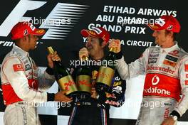 14.11.2010 Abu Dhabi, Abu Dhabi,  2nd place Lewis Hamilton (GBR), McLaren Mercedes with New world Champion and 1st place Sebastian Vettel (GER), Red Bull Racing and 3rd place Jenson Button (GBR), McLaren Mercedes - Formula 1 World Championship, Rd 19, Abu Dhabi Grand Prix, Sunday Podium