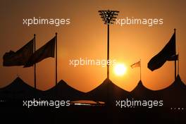 11.11.2010 Abu Dhabi, Abu Dhabi,  The sun sets behind the grandstands - Formula 1 World Championship, Rd 19, Abu Dhabi Grand Prix, Thursday