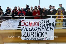 01.02.2010 Valencia, Spain,  Fans watch the action with a banner for Michael Schumacher (GER), Mercedes GP - Formula 1 Testing, Valencia