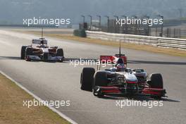 03.02.2010 Valencia, Spain,  Jenson Button (GBR), McLaren Mercedes, MP4-25 leads Fernando Alonso (ESP), Scuderia Ferrari, F10 - Formula 1 Testing, Valencia