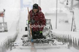 17.12.2010, Engelberg, Switzerland (SUI): Track marshall tries to clean the inrun prior to the qualification- FIS world cup ski jumping, replacing Harrachov, Engelberg (SUI). www.xpb.cc. © Manzoni/xpb.cc. Every downloaded picture is fee-liable.