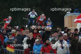 14.01.2011, Ruhpolding, Germany (GER): Emil Hegle Svendsen (NOR), Madshus, Rottefella, Swix, Odlo, Tim Burke (USA), Rossignol, Rottefella, Swix, adidas - IBU world cup biathlon, sprint men, Ruhpolding (GER). www.xpb.cc. © Manzoni/xpb.cc. Every downloaded picture is fee-liable.