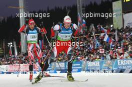 11.03.2011, Khanty-Mansiysk, Russia (RUS): Dominik Landertinger (AUT), Fischer, Rottefella, Leki, Scott Perras (CAN), Madshus, Rottefella, Alpina, Swix - IBU world championships biathlon, relay men, Khanty-Mansiysk (RUS). www.xpb.cc. © Manzoni/xpb.cc. Every downloaded picture is fee-liable.