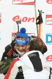 05.03.2011, Khanty-Mansiysk, Russia (RUS): Magdalena Neuner (GER), Fischer, Rottefella, Exel, adidas and Jim Carrabre (CAN), IBU vice president responsible for medical issues  - IBU world championships biathlon, sprint women, Khanty-Mansiysk (RUS). www.xpb.cc. © Manzoni/xpb.cc. Every downloaded picture is fee-liable.