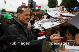 25.03.2011 Melbourne, Australia,  Michael Schumacher (GER), Mercedes GP Petronas F1 Team signs an autograph - Formula 1 World Championship, Rd 01, Australian Grand Prix, Friday