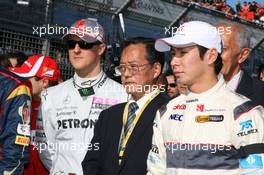 27.03.2011 Melbourne, Australia,  Michael Schumacher (GER), Mercedes GP Petronas F1 Team and The F1 drivers stand for a minute silence for Japan - Formula 1 World Championship, Rd 01, Australian Grand Prix, Sunday Pre-Race Grid