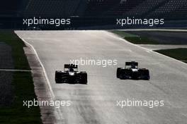 10.03.2011 Barcelona, Spain,  Vitaly Petrov (RUS), Lotus Renault F1 Team and Adrian Sutil (GER), Force India  - Formula 1 Testing - Formula 1 World Championship