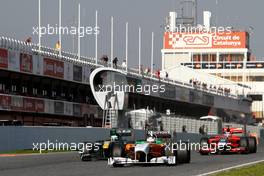 10.03.2011 Barcelona, Spain,  Adrian Sutil (GER), Force India, Heikki Kovalainen (FIN), Team Lotus and Jerome d'Ambrosio (BEL), Virgin Racing  - Formula 1 Testing - Formula 1 World Championship