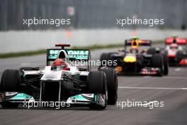 12.06.2011 Montreal, Canada,  Michael Schumacher (GER), Mercedes GP Petronas F1 Team leads Jenson Button (GBR), McLaren Mercedes and Mark Webber (AUS), Red Bull Racing - Formula 1 World Championship, Rd 07, Canadian Grand Prix, Sunday Race