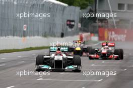 12.06.2011 Montreal, Canada,  Michael Schumacher (GER), Mercedes GP Petronas F1 Team leads Jenson Button (GBR), McLaren Mercedes and Mark Webber (AUS), Red Bull Racing - Formula 1 World Championship, Rd 07, Canadian Grand Prix, Sunday Race