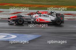 12.06.2011 Montreal, Canada, Jenson Button  (GBR) Vodafone McLaren Mercedes, Vitantonio Liuzzi (ITA) HRT F1 Team  - Formula 1 World Championship, Rd 7, Canadian Grand Prix, Sunday Race